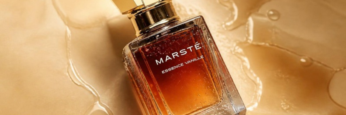 House of Marsté Essence Vanille eau de parfum bottle with water droplets on a warm caramel surface