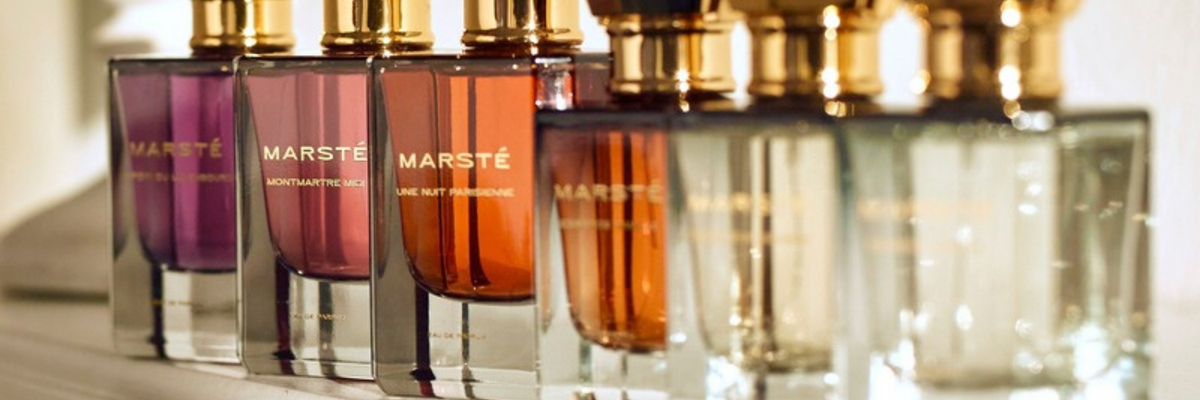 House of Marsté fine fragrances and layering essences lined up on a fireplace mantel