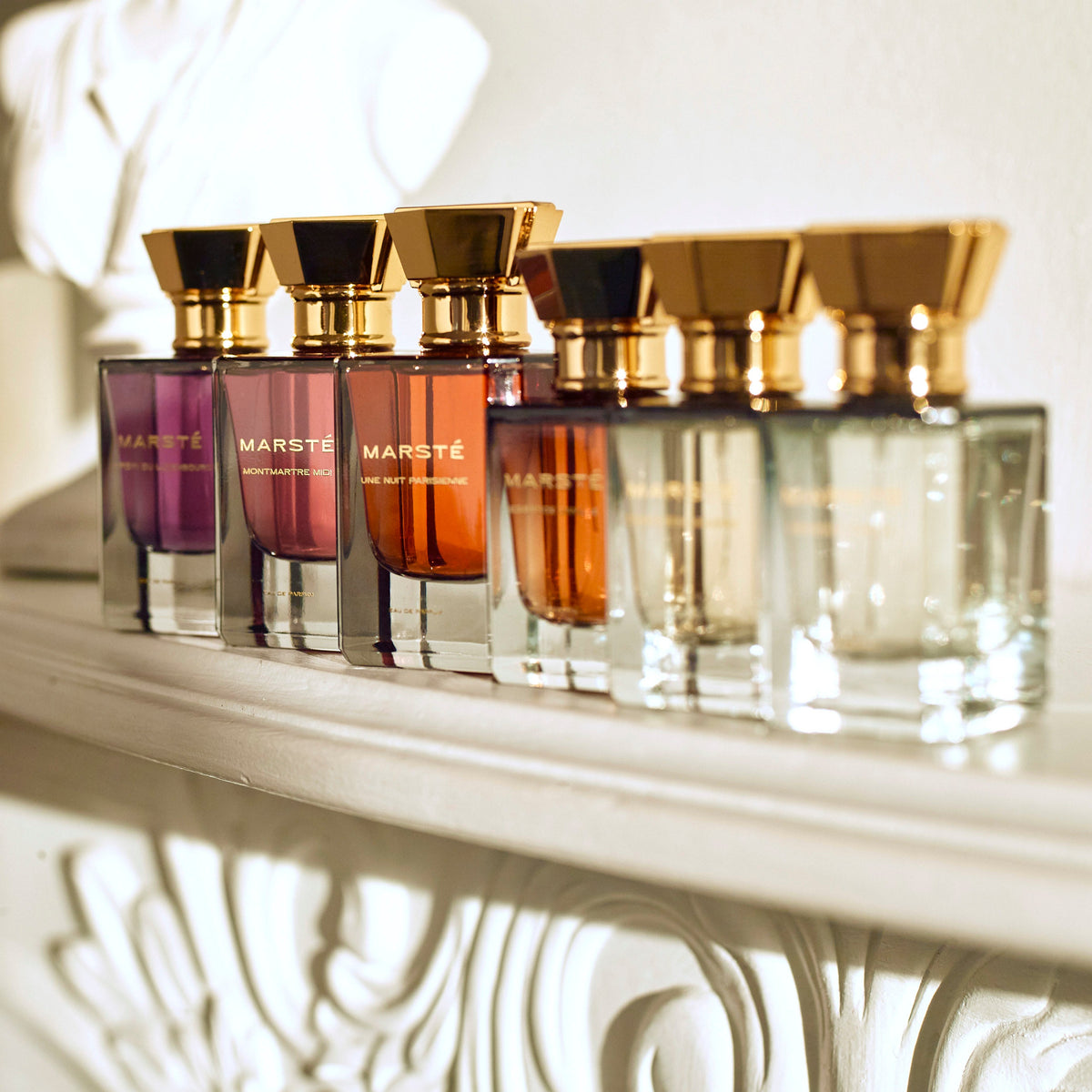 House of Marsté fine fragrance collection displayed on fireplace mantel